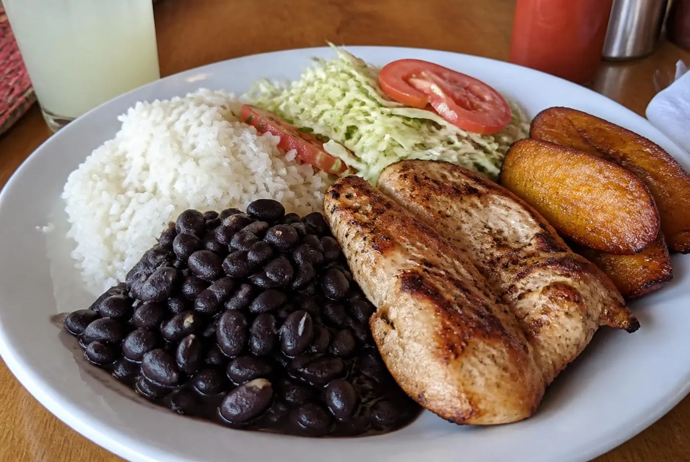 Costa Rican casado with rice, black beans, cabbage salad and grilled chicken