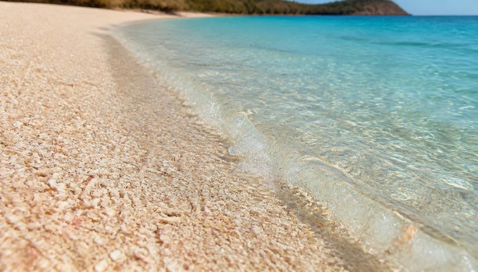 Crushed seashell sand and clear turquoise water at Playa Conchal, Costa Rica