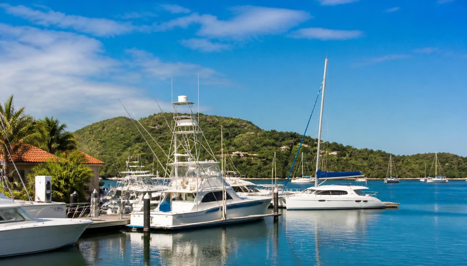 Sport fishing boats and catamarans moored at the Flamingo Beach marina in Guanacaste, Costa Rica